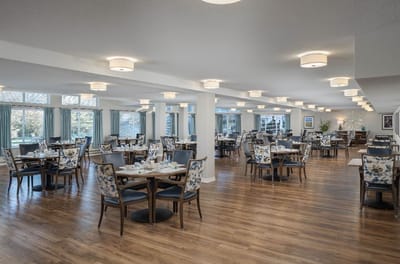 Dining area with tables and chairs in a bright space