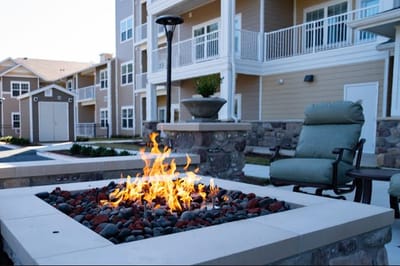 Outdoor fire pit area with seating and landscaping