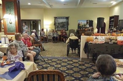 Residents enjoying a festive indoor activity with decorations