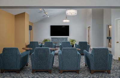 Comfortable lounge area with chairs and large TV