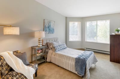 A well-furnished resident room with natural light