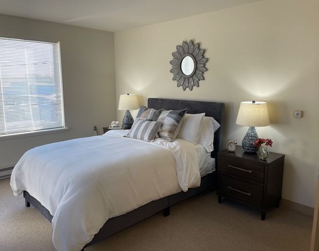 Cozy interior of a resident room with a bed and decor
