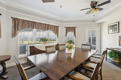 Bright dining area with large windows and wooden table