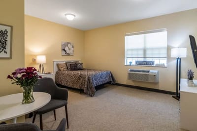 Cozy private resident room with bed and decor
