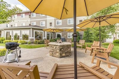 Outdoor seating area with umbrellas and grill