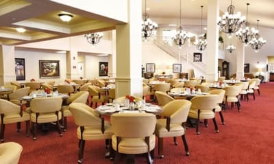 Dining room with elegantly set tables in a senior living facility