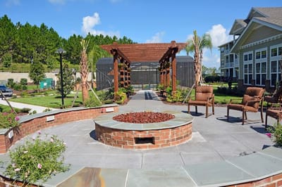 Outdoor garden area with seating and a fire pit