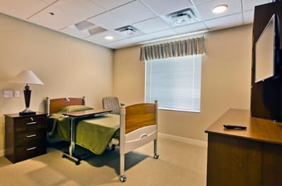 A private resident room with a bed and window