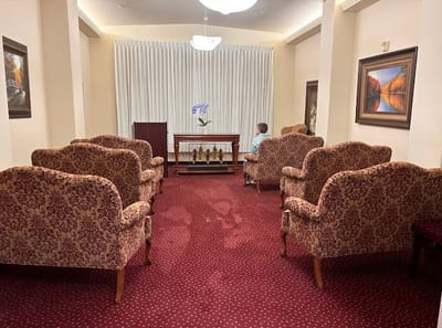Residents seated in a cozy common area with patterned chairs