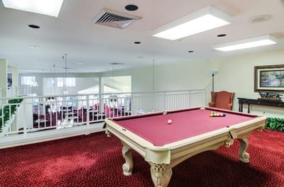Interior view of a game room with pool table