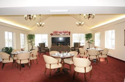 Bright dining room with table settings and plants
