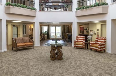 Common area with seating and decor in a senior living facility
