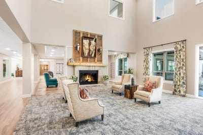 Bright common area with seating and fireplace