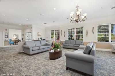 Comfortable common area with seating and floral arrangement