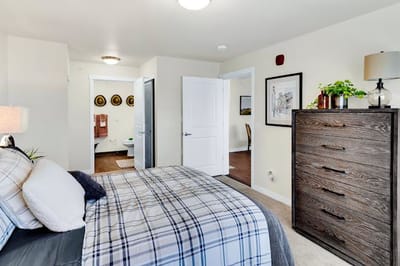 Cozy interior of a resident room with a bed and dresser