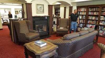 Cozy lounge area with bookshelves and seating