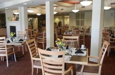 Dining area with tables set for residents