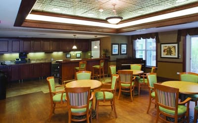 Bright common area with seating and kitchen amenities