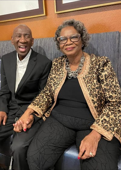 Two smiling residents enjoying time together in a common area