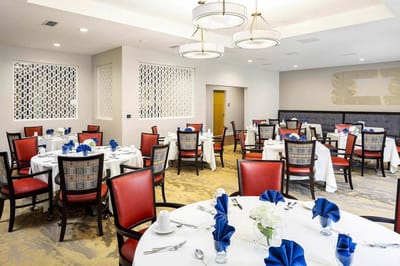 Bright dining room with tables set for a meal