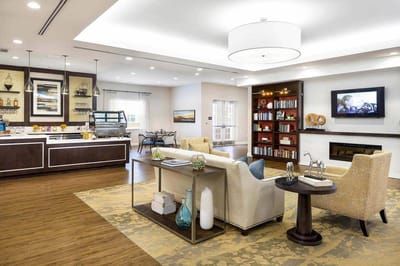 Bright common area with dining space and seating