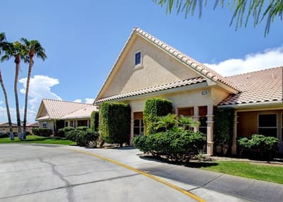 Exterior view of a senior living facility surrounded by greenery