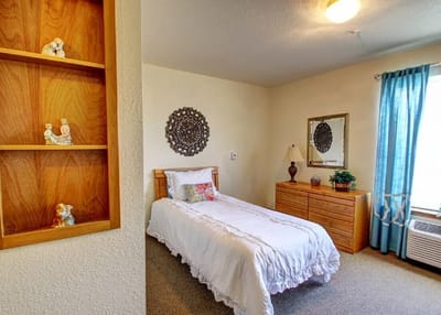 Cozy private room with a bed and decorative shelf