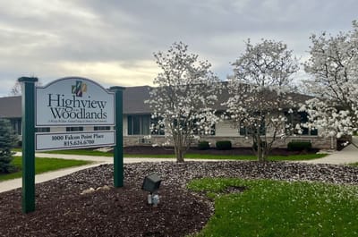 Exterior view of Highview in the Woodlands with flowering trees