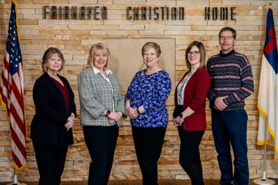 Staff members posing in a common area of the facility