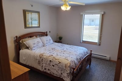 Cozy private resident room with decorative bed and window