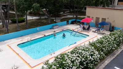 Aerial view of a pool area with residents enjoying.