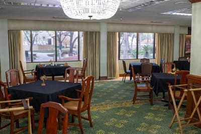 Dining area with tables and chairs set up for meals