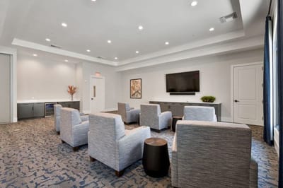 Bright common area with seating and a TV