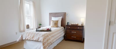 Cozy private resident room with a bed and decor