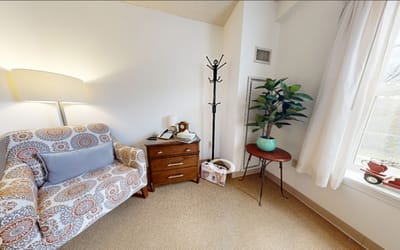 Cozy resident room with a couch and plant