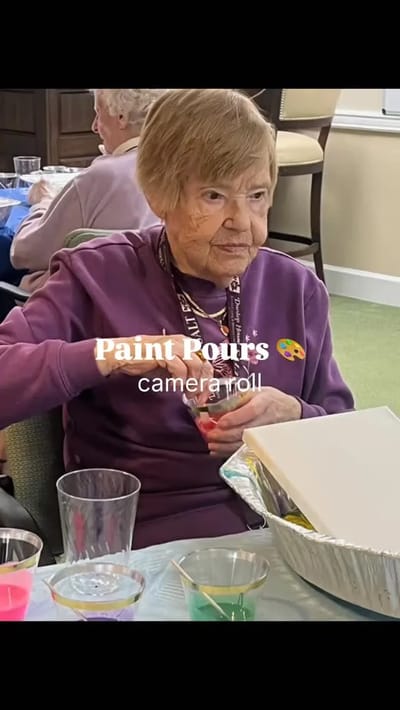 Resident participating in a paint pouring activity