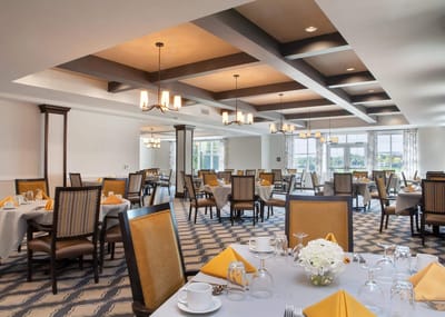 Elegant dining room with neatly set tables and flowers