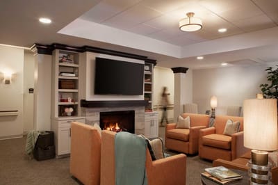 Cozy common area with seating by a fireplace