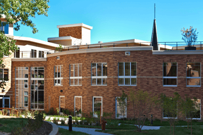 Exterior view of the Highland Path building with landscaping