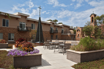 Outdoor space with seating and landscaping in a senior living facility