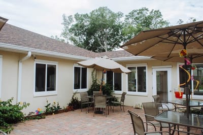 Outdoor patio area with tables and umbrellas