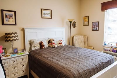 A cozy bedroom at an assisted living facility with personal touches