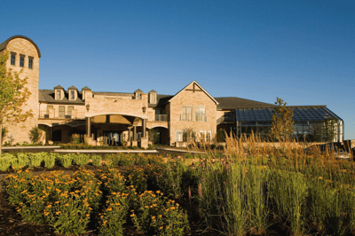 Exterior view of Highland Path with gardens and flowers