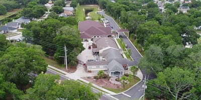 Aerial view of an assisted living facility surrounded by greenery