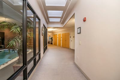 Interior hallway with skylights and doors leading to rooms