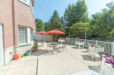 Outdoor patio area with tables and red umbrellas