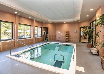 Indoor swimming pool area with large windows