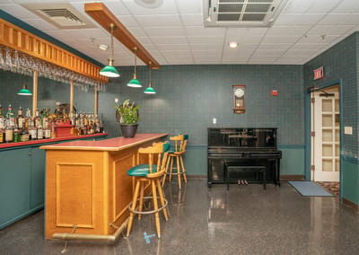 Interior view of a bar area with seating and piano