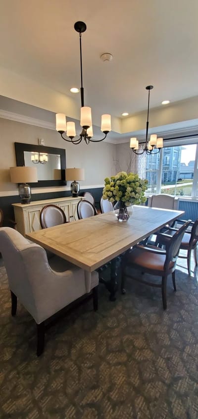 Bright dining room with a large table and floral centerpiece
