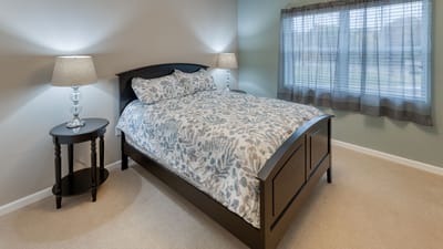 Cozy resident room with a bed and side table